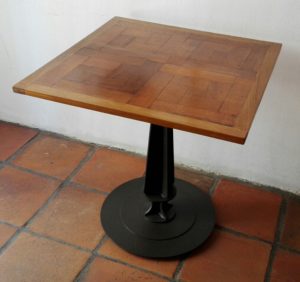 Table created from reclaimed parquet on steel pedestal base