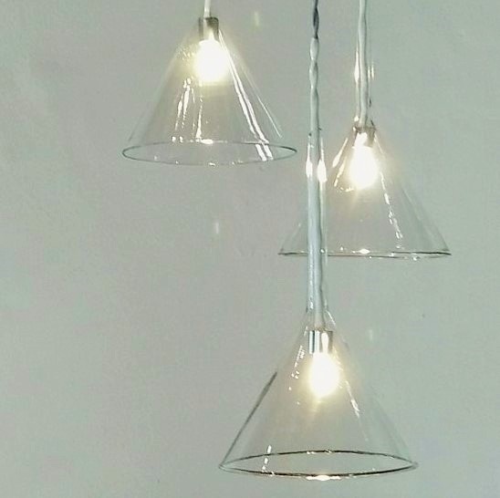 Photograph of hanging lights created by Riaan Chambers from reclaimed laboratory glass.